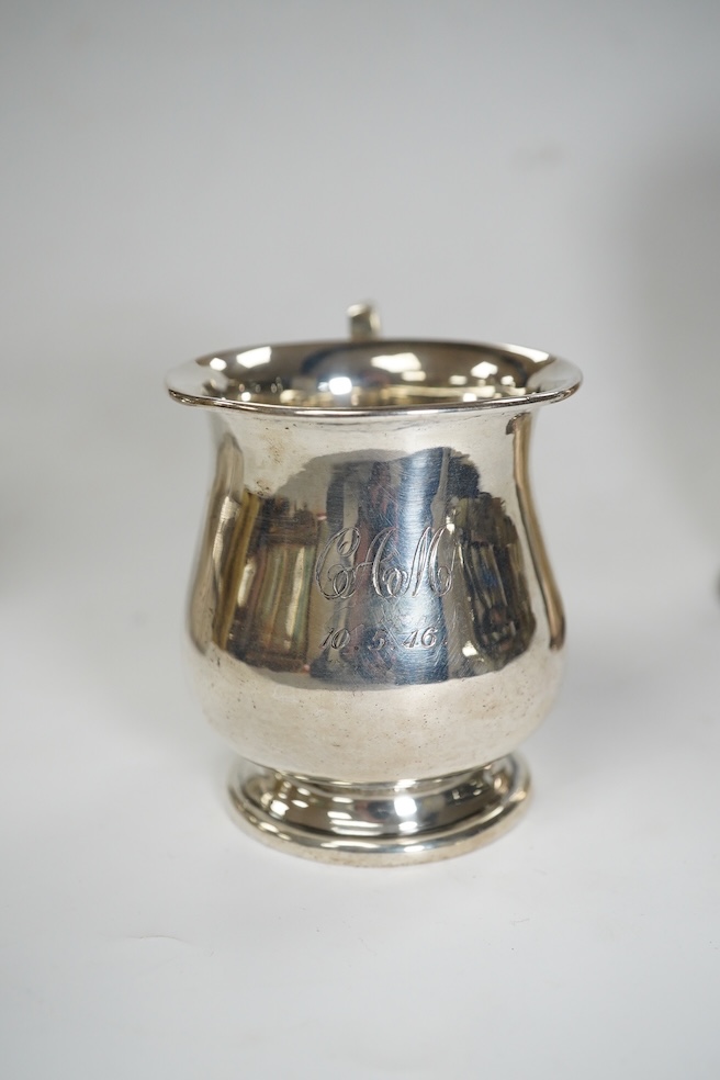 A late Victorian silver Guernsey milk can, marks rubbed, 14cm, a small silver mug and a Scottish silver kitchen pepper, Hamilton & Inches, Edinburgh, 1898, gross weight 16.4 oz. Condition - poor to fair